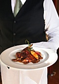 Fowl breast with sun-dried tomatoes and mushrooms on plate, Guinea