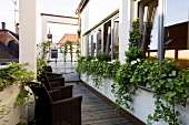 Wicker chairs in balcony of Hotel Goliath, Regensburg, Bavaria, Germany
