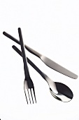 Silver knife, fork and spoon on white background