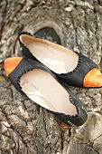 Close-up of black and orange ballerinas shoes