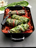 Chard rolls with ginger and tomatoes in baking dish