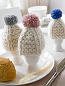 Close-up of knitted bobble hats of eggs