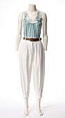 Turquoise top, white trousers and belt on mannequin against white background
