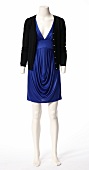 Black cardigan over blue stain dress on mannequin against white background 