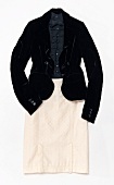 Black velvet blazer with beige quilted skirt on white background