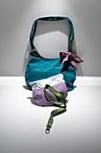 Blue and purple-silver fabric handbags on grey background