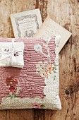 Scented sachets on floral scatter cushion