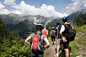 Rear view of mountain bikers looking at mountain ranges, South Tyrol, Italy