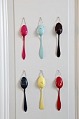 Multi coloured spoons hanging on wall of Mielcke & Hurtigkarl hotel, Copenhagen, Denmark