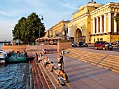 People at Neva shores stairs in Saint Petersburg, Russia