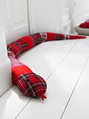 A red checked draught-excluder snake
