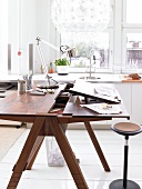 Wooden table with table light in front of window in kitchen