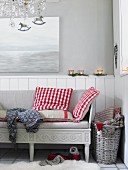 A bench with red and white checked cushions in a Scandinavian-style room