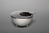 Stainless steel ashtray on gray background