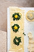 Filling the dough type with quail eggs and parsley farce, overhead view