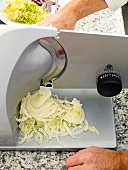 Close-up of shaving fennel on cutting machine