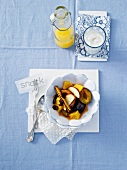 Cinnamon with orange, plum and apple slices in bowl