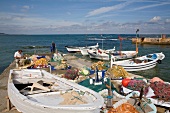 Fishermen with boat and fishing net on jetty in Kilyos, Istanbul, Turkey