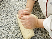 Dough being kneaded on marble platform