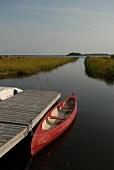 View of red boat moored at jetty, Muhu, Estonia, Russia