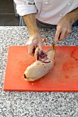 Cutting duck on cutting board