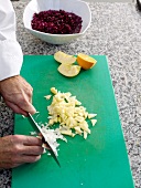 Chopping white onion on cutting board