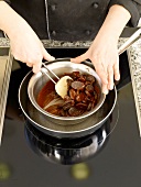 Melting chocolate in a vessel immersed in boiling water in saucepan