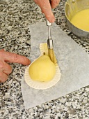 Brushing design on puff pastry with butter