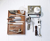 Various knives and kitchen utensils on white background