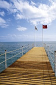 View of sea pier with flags in Antalya, Turkey