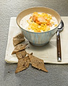 Cream of potato soup in bowl with crackers
