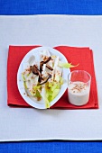 Chicory salad with dates and yogurt dressing in serving dish