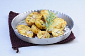 Roast potatoes with rosemary in steel baking dish