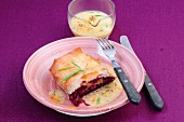 Red cabbage strudel with orange sauce on plate