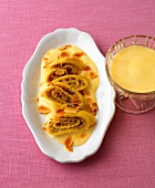 Bowl of grappa sabayon and hazelnut pancakes on plate