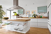 Kitchen in white with wooden flooring and working surface