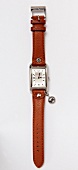 Close-up of wrist watch with leather strap on white background