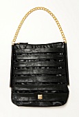 Black bag with golden link chain handle on white background