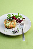 Vegetable tartare with red cabbage and rocket leaves on plate