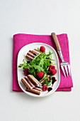 Pumpernickel salad with raspberries and rocket leaves on plate