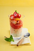 Strawberry and orange salad on lemon ice cream in glass