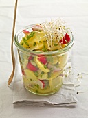Close-up of potato and radish salad with sprouts in jar