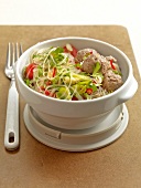 Noodle salad with meatballs in bowl