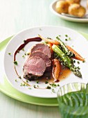 Veal fillet with a herb crust, green asparagus and carrots