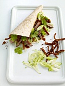 Close-up of wraps with peking duck on tray