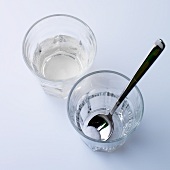 Lemonade and water with 1 tea spoon sugar in glasses