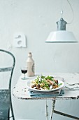 Spaghetti with fried mushrooms on a shabby chic-style table