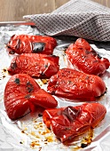 Close-up of baked skinned red peppers on plate, step 1