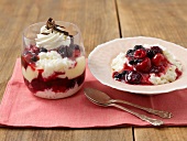 Rice pudding with berry compote in glass and in serving dish