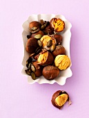 Baked chestnuts with shell in bowl